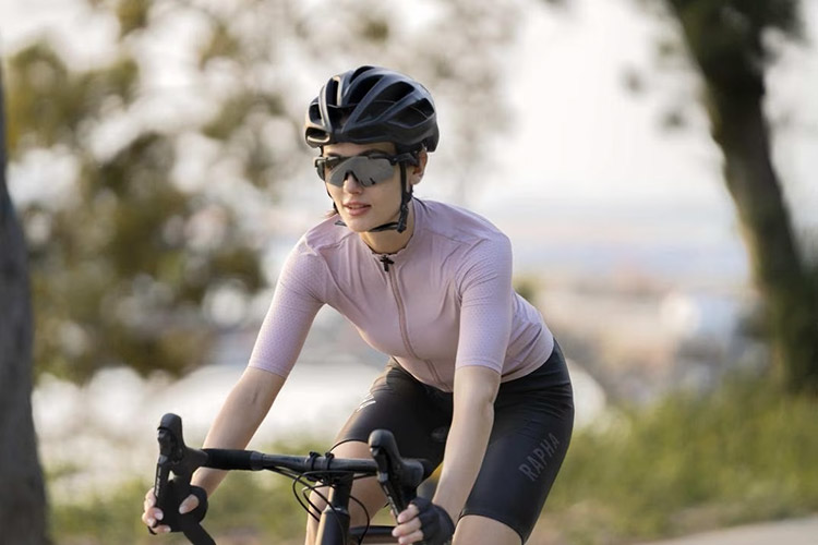 woman riding a bike and wearing cycling sunglasses